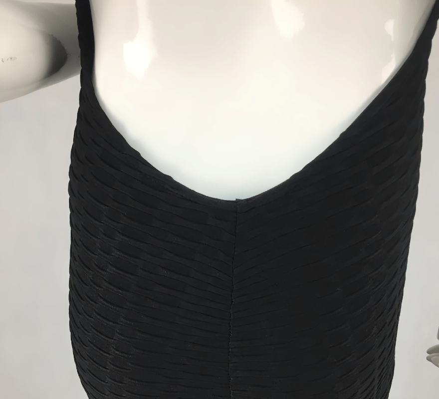 Close-up of Women's Textured Open-Back Yoga Jumpsuit in black, highlighting the breathable fabric and textured design.
